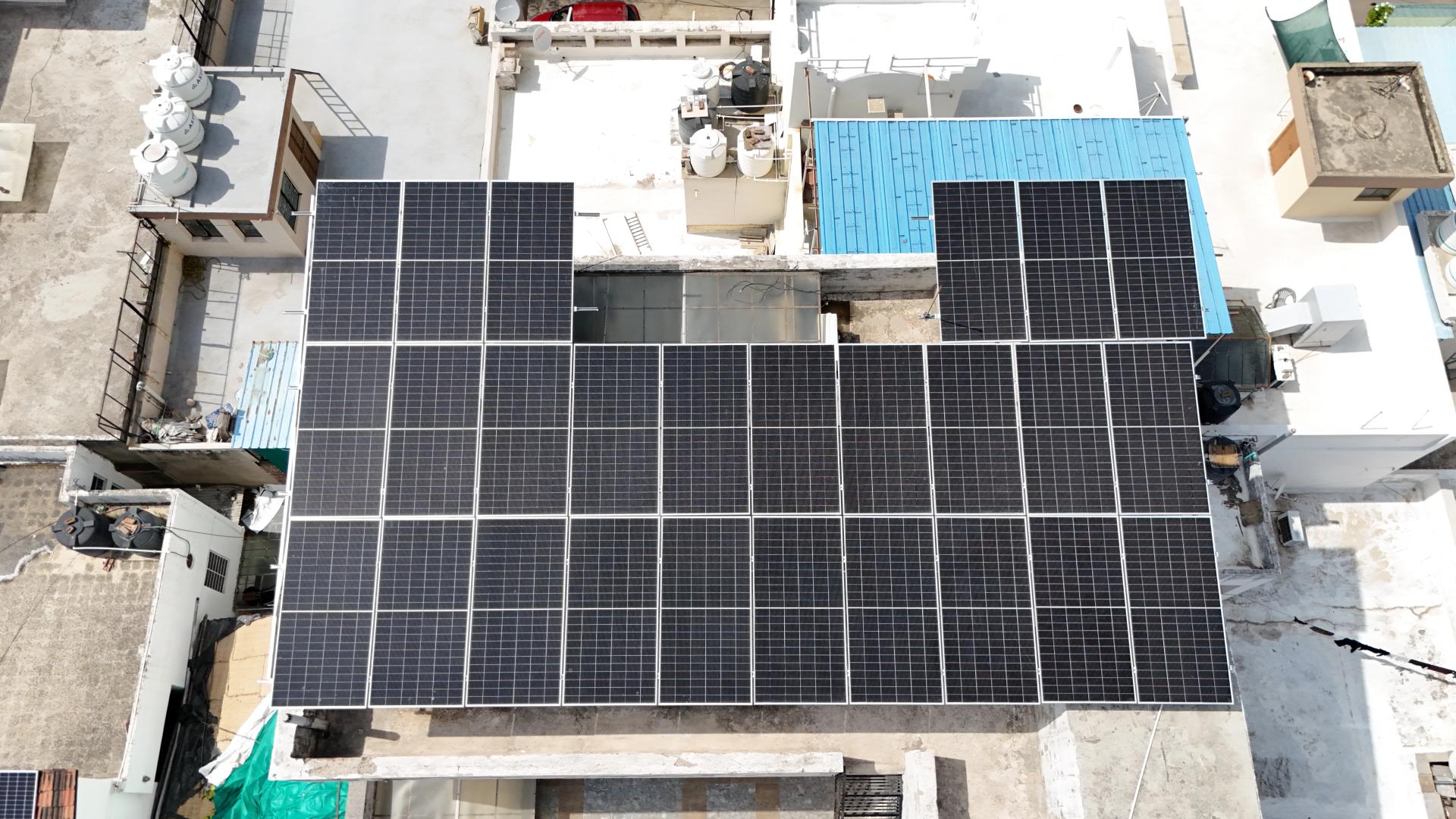 Aerial view of a large Renewray rooftop solar installation — 40+ panels covering a residential terrace